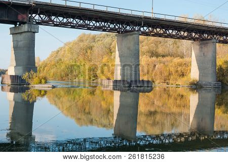 Old Bridge Over The River. Autumn Landscape With A Bridge