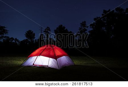 Red Topped Nylon Tent Lit With The Stars Above