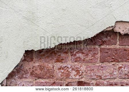 Fragment Of Brick Wall With Damaged Plaster