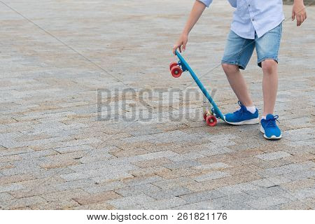Beautiful Boy In Asvalte Does A Skateboard Trick