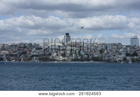 The Clouds Above The Buildings Of A Big City With Sea.