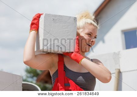 Strong Pretty Woman Working On Construction Site, Building House, Installing Gray Airbricks. Industr