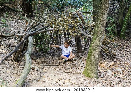 Little Boy In His Homemade Cabin On The Woods
