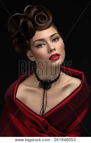 Beautiful Young Woman With Fancy Hairdo And Red Lips