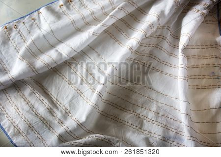 People Working Batik Tie Dyeing Indigo Process Fold Bundle And Sewing Or Arashi Shibori On Fabric At