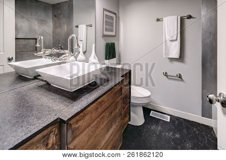 Luxurious Bathroom Interior Boasts Modern Dark Grey Vanity Cabinet.