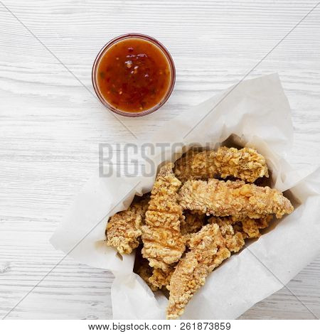 Chicken Tenders In Paper Box With Sauce On A White Wooden Background, Overhead View. Flat Lay, Top V