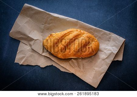White Bread Rolls On Crafting Wrapping Paper On A Dark Table Background.