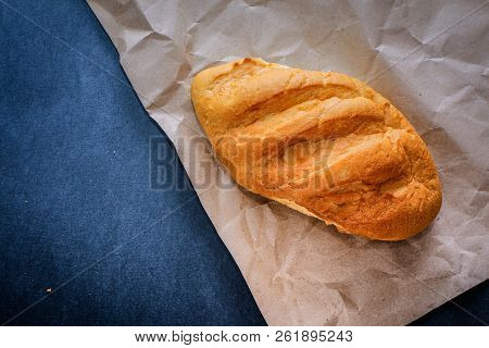 White Bread Rolls On Crafting Wrapping Paper On A Dark Table Background.