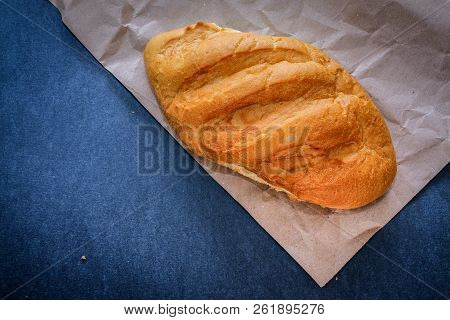 White Bread Rolls On Crafting Wrapping Paper On A Dark Table Background.