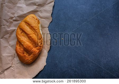 White Bread Rolls On Crafting Wrapping Paper On A Dark Table Background.