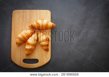 A Rich Variety Of Food Photography Croissant.
Four Croissants On A Wooden Light Cutting Board On Dar