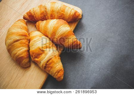A Rich Variety Of Food Photography Croissant.
Four Croissants On A Wooden Light Cutting Board On Dar