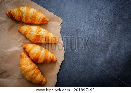 A Rich Variety Of Food Photography Croissant.
Four Croissants On Brown Craft Paper On A Dark Contras