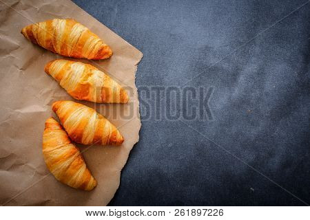 A Rich Variety Of Food Photography Croissant.
Four Croissants On Brown Craft Paper On A Dark Contras