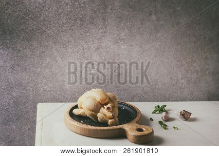 Raw Organic Uncooked Whole Yellow Corn Mini Chicken On Wooden Cutting Board With Salt, Herbs And Gar
