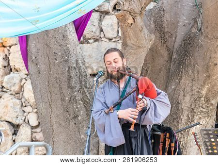 Jerusalem, Israel, September 29, 2018 : Musician In Authentic Costume Plays The Bagpipes For Visitor