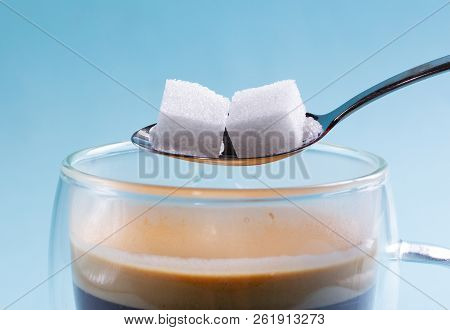 To Cubes Of Sugar In Spoon Over Cup Of Coffee