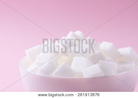Sugar Cubes In White Plate On Pink Background Close Up