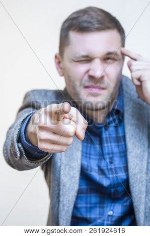 Portrait Of Young Venturesome Man Pointing With Index Finger On Camera And Showing Hand Sign, You Ar