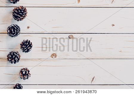 Pine Cones On Rusticwood White Background With Copy Space,
