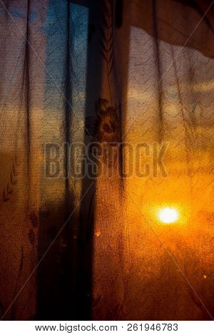 Through The Curtain Shines The Setting Sun
