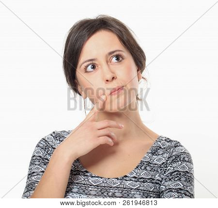 Thoughtful Young Woman Holding Her Forefinger At Cheek
