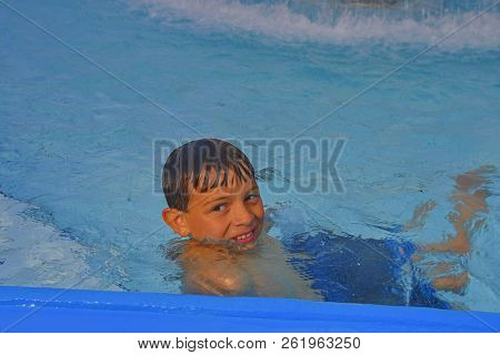 Cute Little Boy In The Public Swimming Pool. Portrait Of Little Cute Boy In The Swimming Pool. Sunny