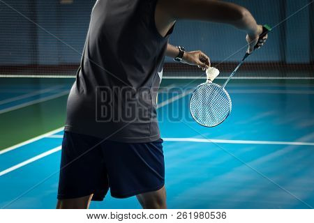 People Playing Badminton, Badminton Is Served On Court Blue Background.