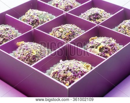 Closeap Photo With Focus In The Center Of Sweets Sprinkled With Rose Petals