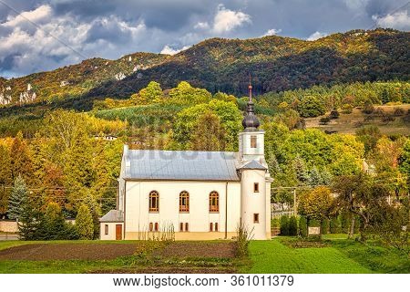 Church In Sulov - Hradna With Background Of Sulov Rocks At Autumn, Slovakia, Europe.