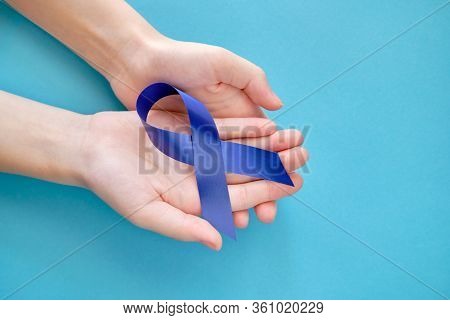 Blue Ribbon On On Two Hands Is A Symbol Of The Problem Of Stevens-jones Syndrome, Colon Cancer, Prob