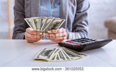 Budget Planning In Crisis. Female Hands Consider Dollars, Panorama