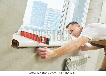 vinyl windowsill installation at apartment during renovation