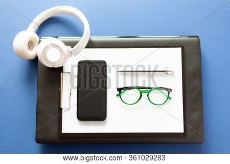 On A Laptop Are Paper Pen Glasses Glasses Smartphone, Mobile Office, Remote Work