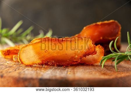 Seasoned Chicken With Hot Sauce And A Sprig Of Rosemary
