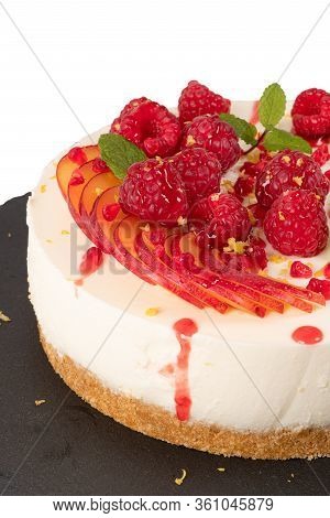 Cheesecake With Raspberriees, Plum And Mint Leaves Isolated On Ehite Background