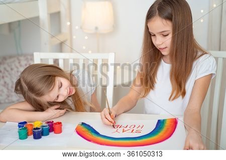 Sisters Drawing On A White Sheet Rainbow And Write Stay Home. Flashmob Chasetherainbow.