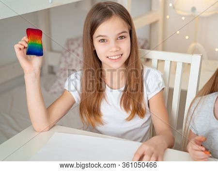 Teen Girl Drawing With A Sponge On A White Sheet Rainbow. Stay At Home. Flashmob Chasetherainbow.