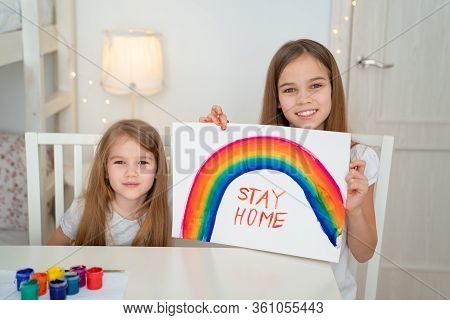 Little Girls Drawing On A White Sheet Rainbow And Write Stay Home. Flashmob Chasetherainbow.