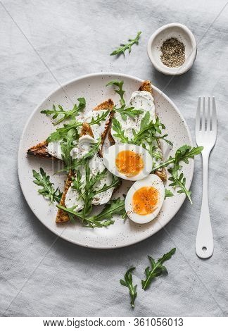 Delicious Breakfast, Brunch Or Snack - Cheese Toast, Arugula Salad And Soft Boiled Egg On A Grey Bac