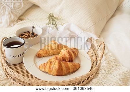 Close Up Of Tray With Coffee Cup, Croissants, Muesli And White Flowers On Knitted Blanket At Cozy Sc