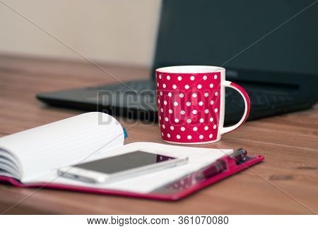 Workingat Home - Computer And Notebok With Teacup. Cup Of Cappuccino And Notebook Near Phone And Lap