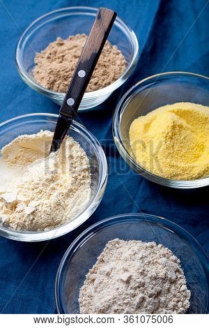 Various Vegetable Gluten Free Flour Corn,sesame,oat,coconut In Glass Bowl On Blue Textile Background