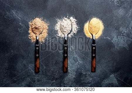 Various Vegetable Gluten Free Flour Corn,sesame,oat,coconut In Spoon On Dark Gray Background.alterna