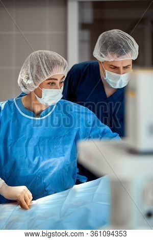 Photographs Of Doctors In Protective Masks And Lab Coats Work Intensively In Intensive Care. Resusci