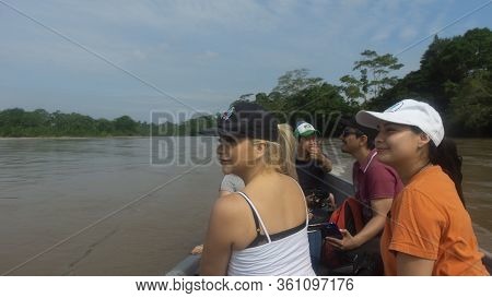 Lago Agrio, Sucumbios / Ecuador - February 20 2020: Group Of Tourists Sailing In A Wooden Boat On Th