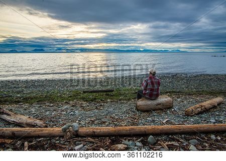 Beautiful Sunset Along A Rocky Beach With Big Waves
