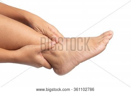Woman With Ankle Pain Using Two Hands Holding Leg And Massaging Painful Her On Isolated. Discomfort 