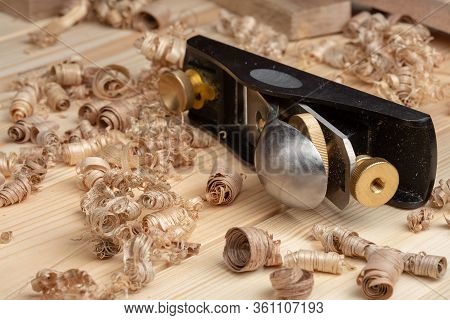 Small Block Plane With Wood Shavings On The Workbench